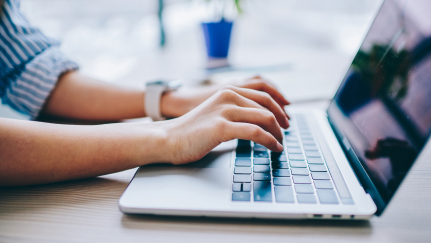 hands on a laptop