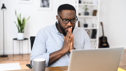 man looking at a laptop